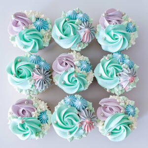 Pastel green, purple mix coloured cupcakes.