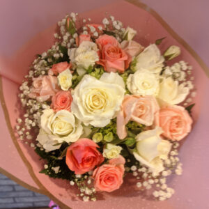 The delicate blooms of Baby's Breath offer a lovely contrast to the fuller roses, adding depth and visual interest.