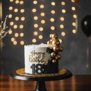 Celebrate a milestone in style with this sophisticated Black and Gold Birthday Cake.