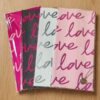 Features a stylish, repeating Love script