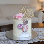 Chic Ivory Bridal Shower Cake with Illustrated Bride and Gold Topper