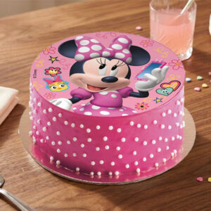 Add a touch of magic to your celebration with this charming Minnie Mouse themed cake! The top features a vibrant, high-quality edible print of the iconic Minnie Mouse in her signature polka-dot dress. The cake is finished with smooth, delightful pink icing and decorated with delicate white sprinkle "polka-dots" along the sides, making it a perfect, whimsical centerpiece for any fan's birthday.